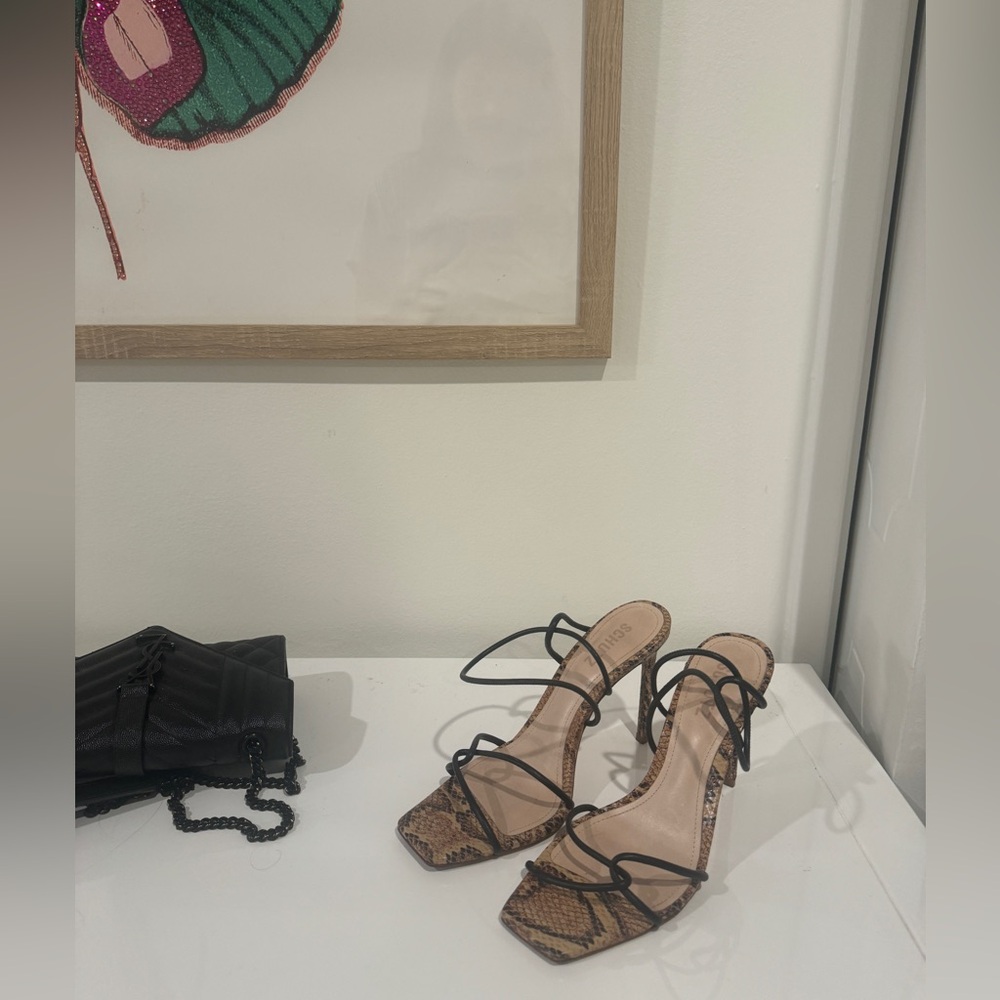 Schutz snakeskin and black pumps